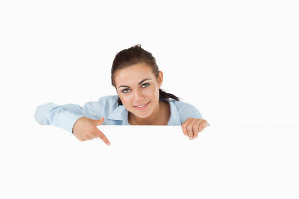 istock Businesswoman pointing on sign under her 827282998