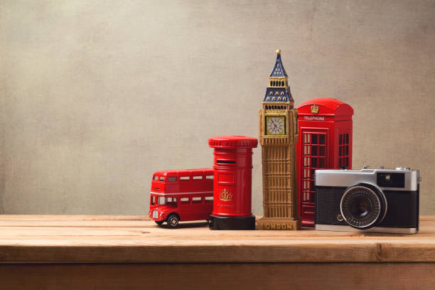 Travel and tourism concept with souvenirs from London and vintage camera on wooden table with copy space Travel and tourism concept with souvenirs from London and vintage camera on wooden table with copy space London Memorabilia stock pictures, royalty-free photos & images