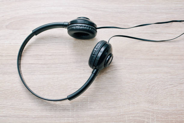 istock Headphones and laptop on table wood 827284758