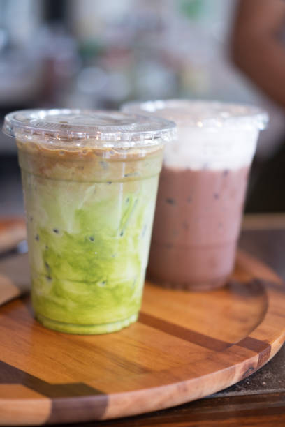istock Ice milk green tea in the plastic grass with ice chocolate background 827288278
