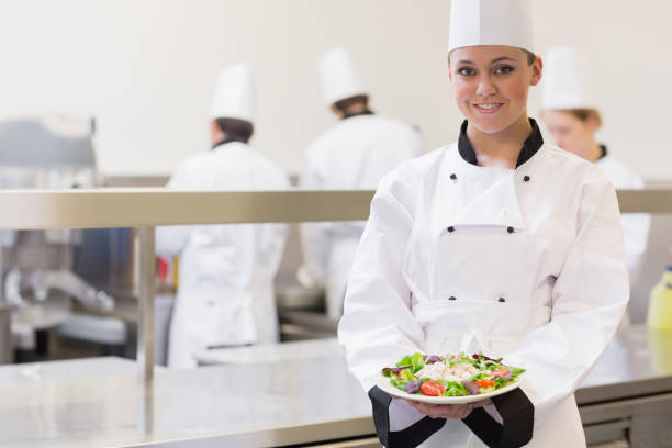 istock Smiling chef showing her salad 827291964