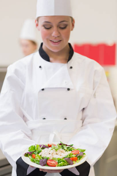 istock Cheerful chef looking at her salad 827292026