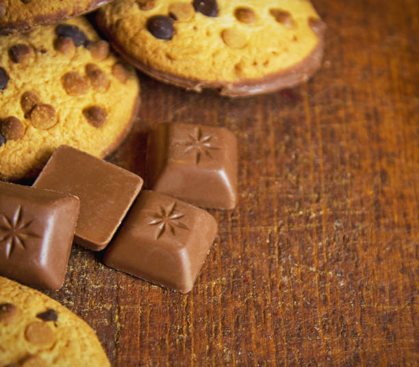 istock Chocolate chip cookies and chocolate candies on rustic wooden background 827292152
