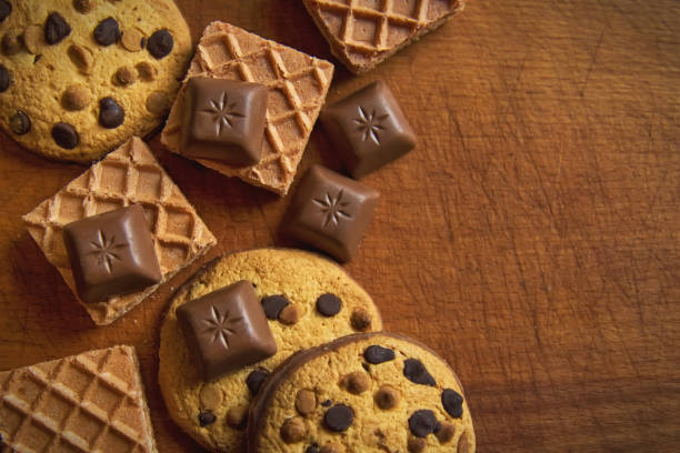 istock Chocolate chip cookies and chocolate candies on rustic wooden background 827292162