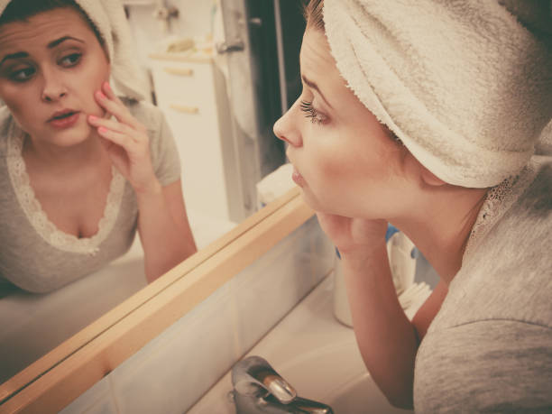 istock Woman looking at her reflection in mirror 827292182