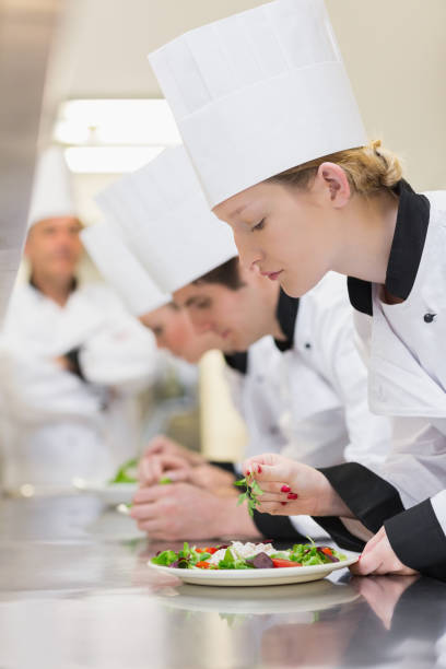 istock Chefs applying finishing touches to salads 827292642