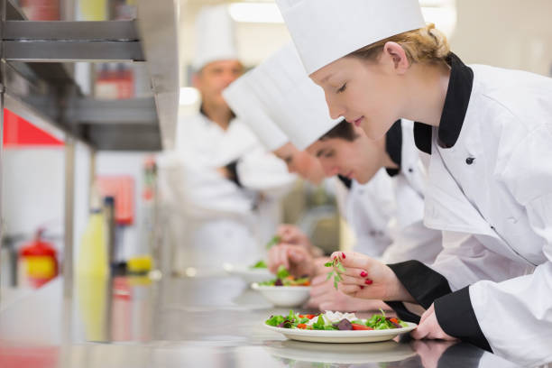 istock Chefs finishing their salads in culinary class 827292720