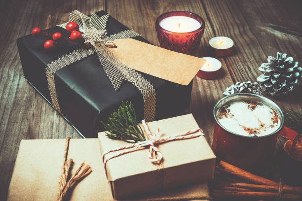 istock Christmas present gift boxes and rustic decoration with candle, hot chocolate 827293698