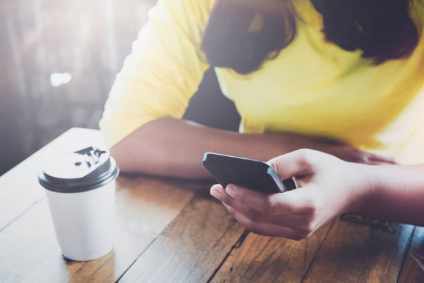 istock young hipster girl using smart phone in cafe 827295254