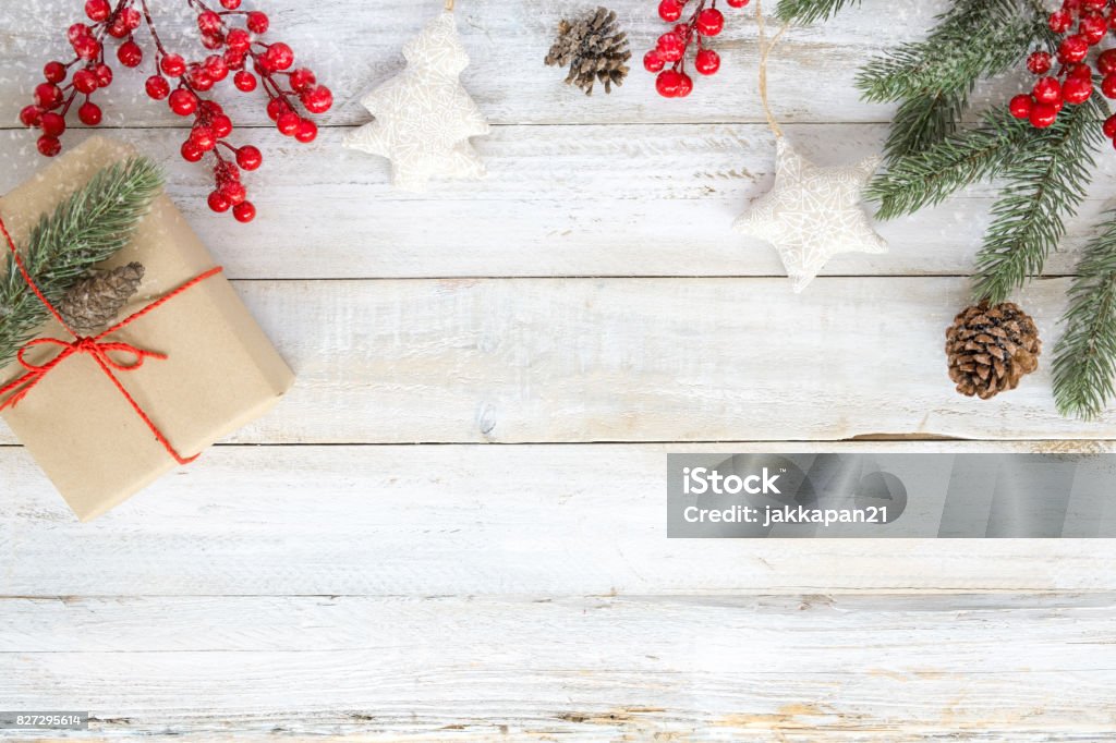 Christmas background with decorations and gift boxes Christmas background with decorations and handmade gift boxes on white wooden board with snowflake. Creative Flat layout and top view composition with border and copy space design. Christmas Stock Photo