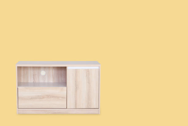 istock Wooden table for  put television on top isolated on yellow background with space for copy. 827299326