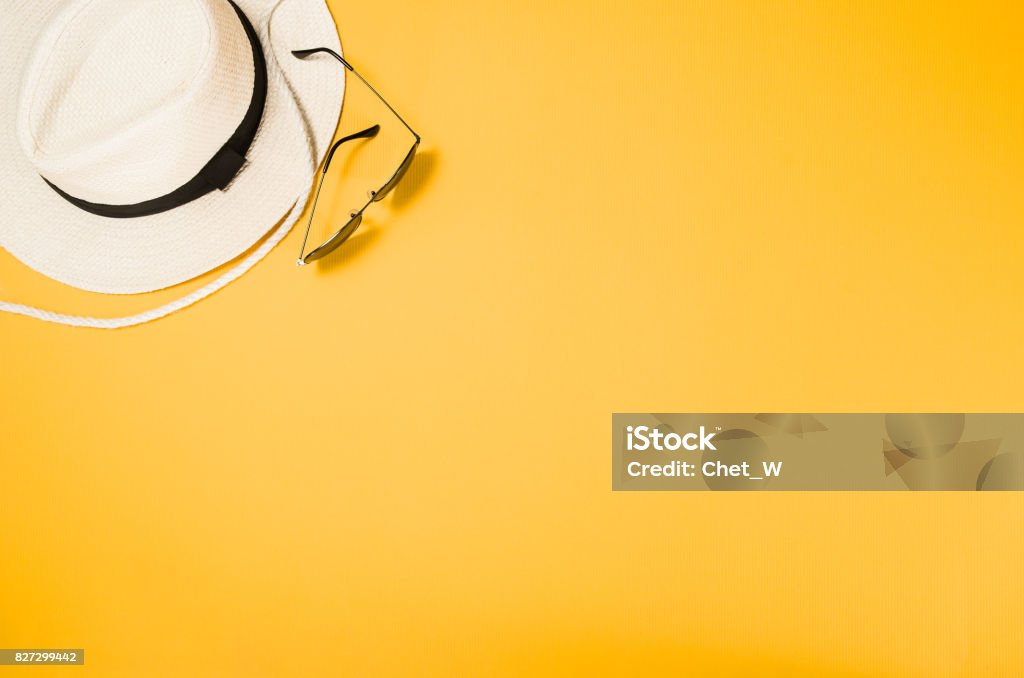 Accessories for travel top view yellow background with copy space Accessories for travel top view on yellow background with copy space. Beach adventure and wanderlust concept image with travel accessories. Sunbathing and relaxing Summer Stock Photo