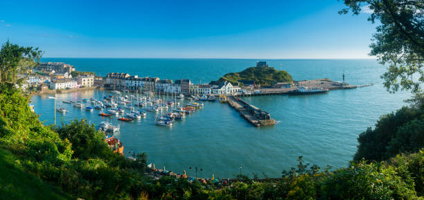 Sunrise over the tourist town of Ilfracombe in Devon Ilfracombe Harbor at sunrise in broad panorama across the picturesque town. devon stock pictures, royalty-free photos & images