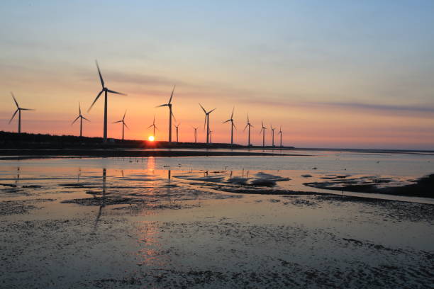istock sunset of wind farm 827312122
