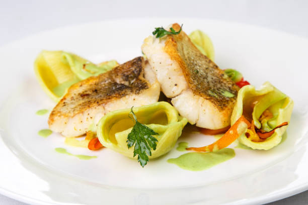 istock Grilled hake fillet in spices and decorations on round plate on 827316076