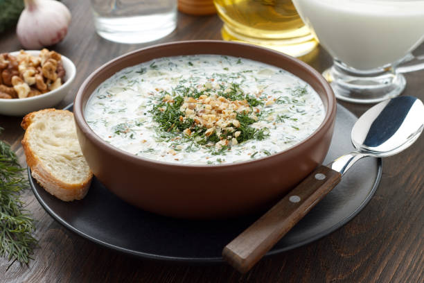 Summer cold soup tarator with yogurt, cucumber, dill and walnuts ready to eat. stock photo