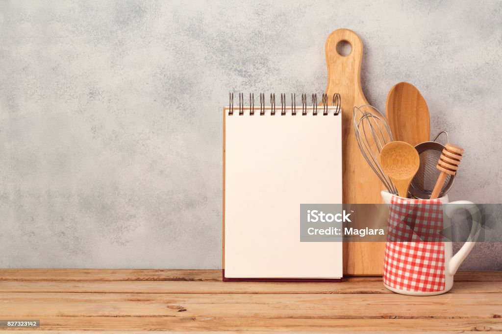 Blank notebook and kitchen utensils on wooden table over rustic background with copy space Recipe Stock Photo