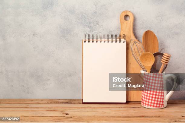 Blank Notebook And Kitchen Utensils On Wooden Table Over Rustic Background With Copy Space Stock Photo - Download Image Now