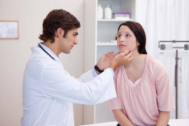 istock Doctor examining his patients jaw 827323208