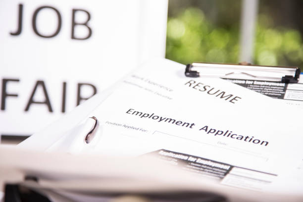 istock Job fair table with employment applications, resumes. 827323578