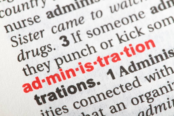istock Closeup of English dictionary page with word ADMINISTRATION. 827323834