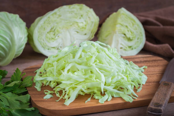 istock Fresh shredded cabbage on wooden cutting board 827327588