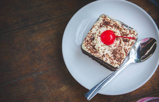 istock tasty chocolate cherry cake dessert on wood table 827338448