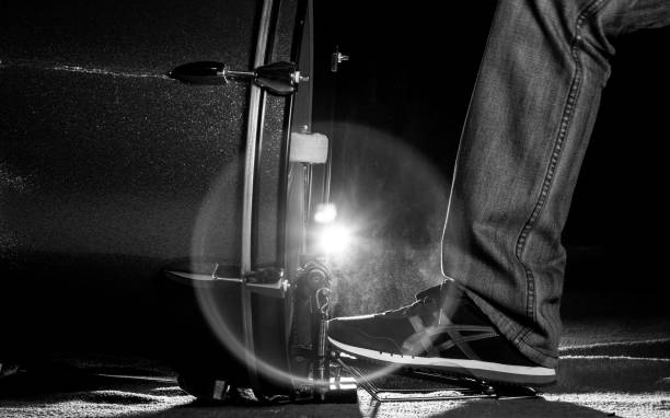The drummer's foot wears sneaker is playing bass drum pedal stock photo