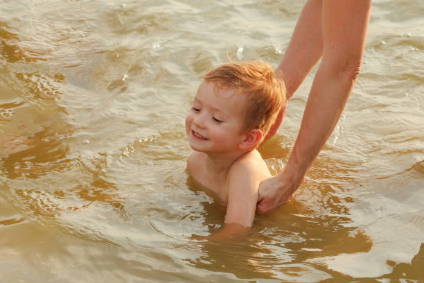 istock Child swimming lake. 827344688