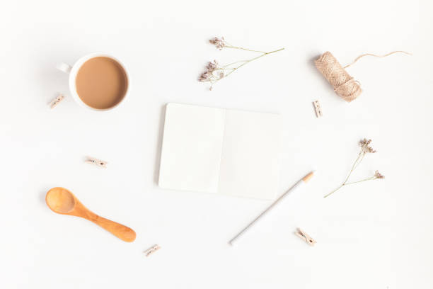 istock Notebook, cup of coffee, cotton flowers. Flat lay, top view 827345132