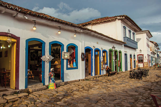 View of shops in old houses and cobblestone at sunset in Paraty. Paraty, Brazil - January 22, 2015. View of shops in old houses and cobblestone at sunset in Paraty, an amazing and historic town totally preserved in Rio de Janeiro State coast, southwestern Brazil paraty brazil stock pictures, royalty-free photos & images