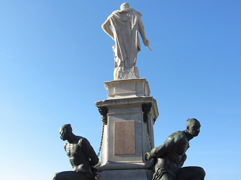 The monument Quattro Mori ( of the Four Moors ) in Livorno city . Rear view of the monument against the blue sky . Tuscany, Italy