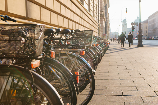 Many bikes in a row on the street in Munich, Germany, Europe. Bicycle parking. Environmentally friendly and healthy means of transportation around the city. healthy lifestyle