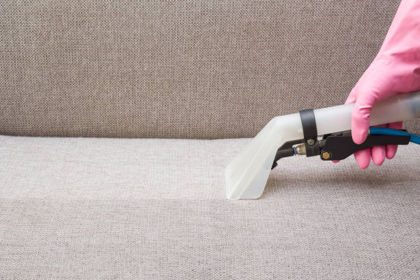 istock Sofa chemical cleaning with professionally extraction method. Hand in rubber protective glove holding nozzle of extractor. Upholstered furniture. Early spring or regular clean up. 827348632