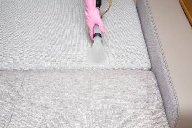 istock Sofa chemical cleaning with professionally extraction method. Hand in rubber protective glove holding nozzle of extractor. Upholstered furniture. Early spring or regular clean up. 827348754