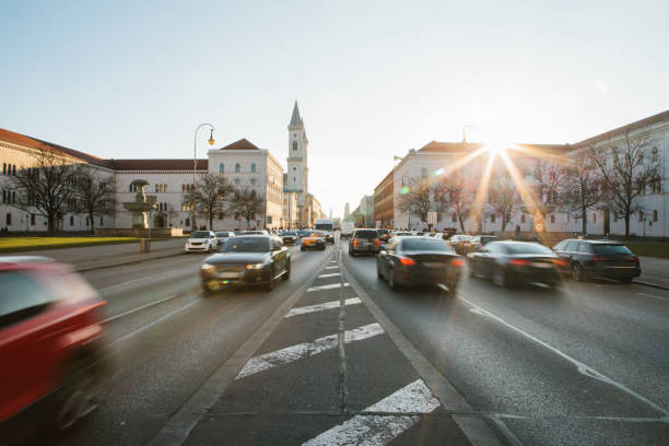 view of the road on the street leopoldstrasse in munich - the capital of bavaria in germany. fast blurred motion car on sunset background. - highway street road speed imagens e fotografias de stock