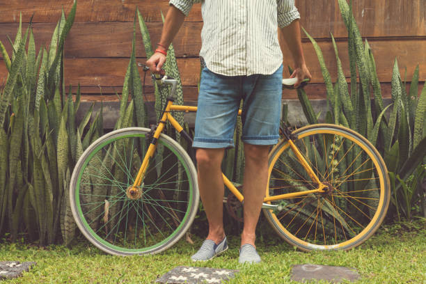 istock Young attractive man enjoying outdoors with old bicycle. 827355224
