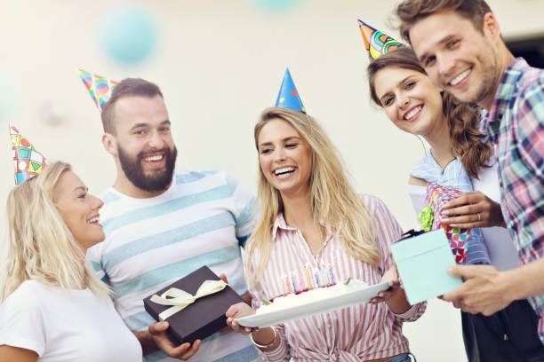 istock Group of friends having fun at birthday party 827355256