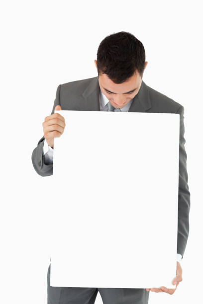 istock Businessman looking at sign in his hands 827356832