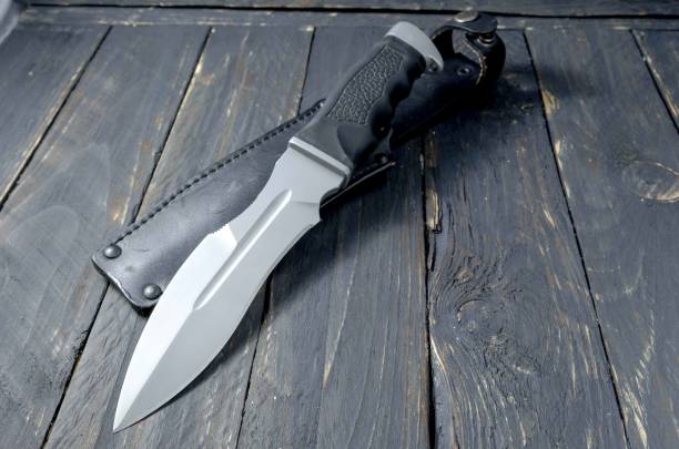 istock Military knife on black background. 827358472