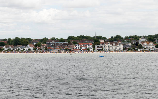 istock people on the beach with Kiel as background 827359746