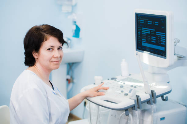 istock Happy mature female doctor using ultrasound scanner. Echography machine 827361906