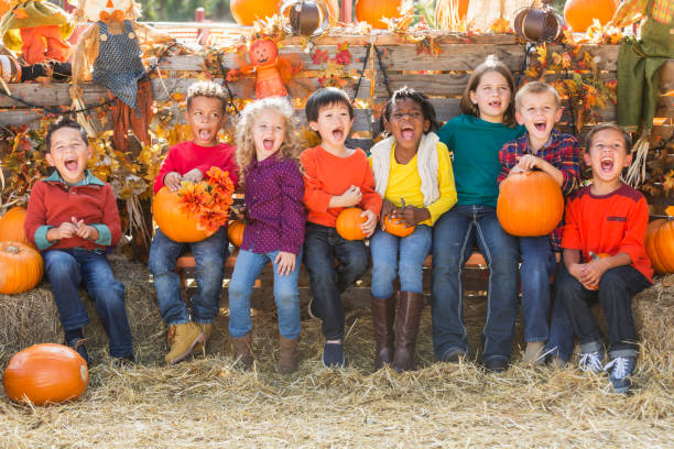 istock Multi-ethnic children with pumpkins at fall festival 827361932
