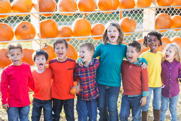 istock Multi-ethnic group of children at pumpkin stand 827362142