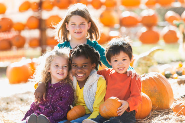 istock Multi-ethnic group of children at pumpkin stand 827362222