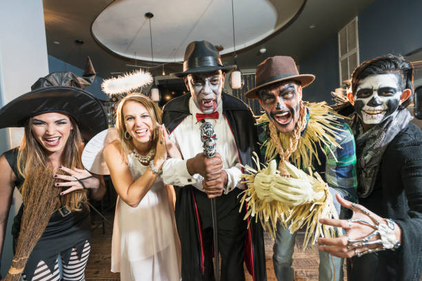 Adult halloween party A group of five multi-ethnic men and women of mixed ages at a halloween party wearing costumes. stage costume stock pictures, royalty-free photos & images