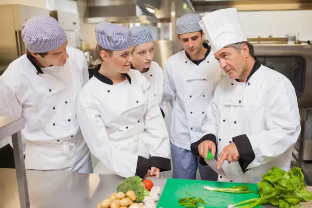 Photo of Trainees learning vegetable slicing