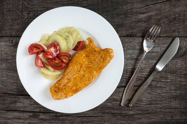 istock Roasted turkey escalope with cucumber and tomato salad 827376370