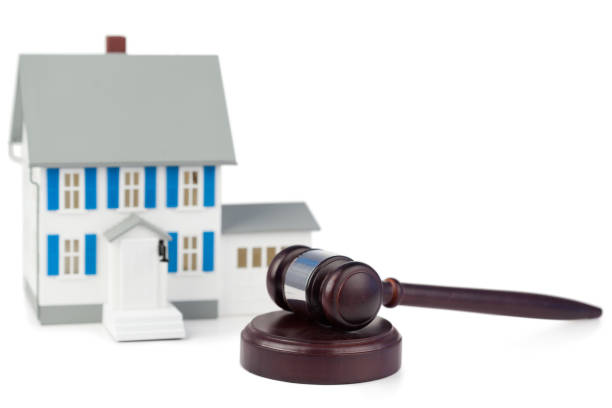 istock Grey toy house model and brown gavel 827376606