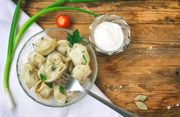 istock Dumplings with herbs on glass bowl, white napkin 827379874